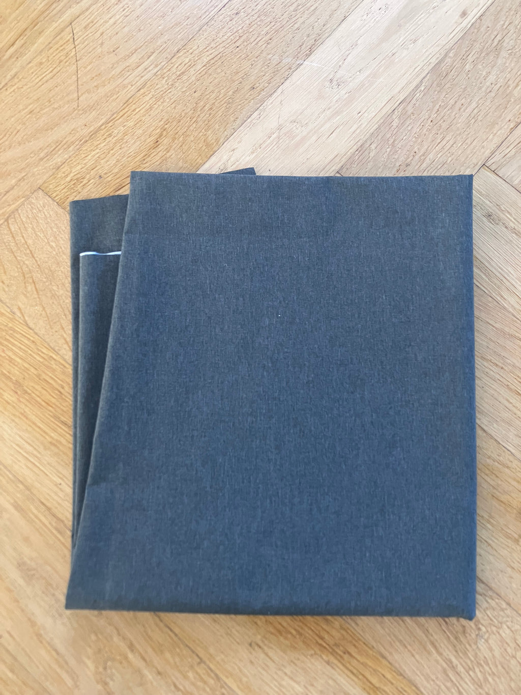 Folded blue fabric on a wooden floor