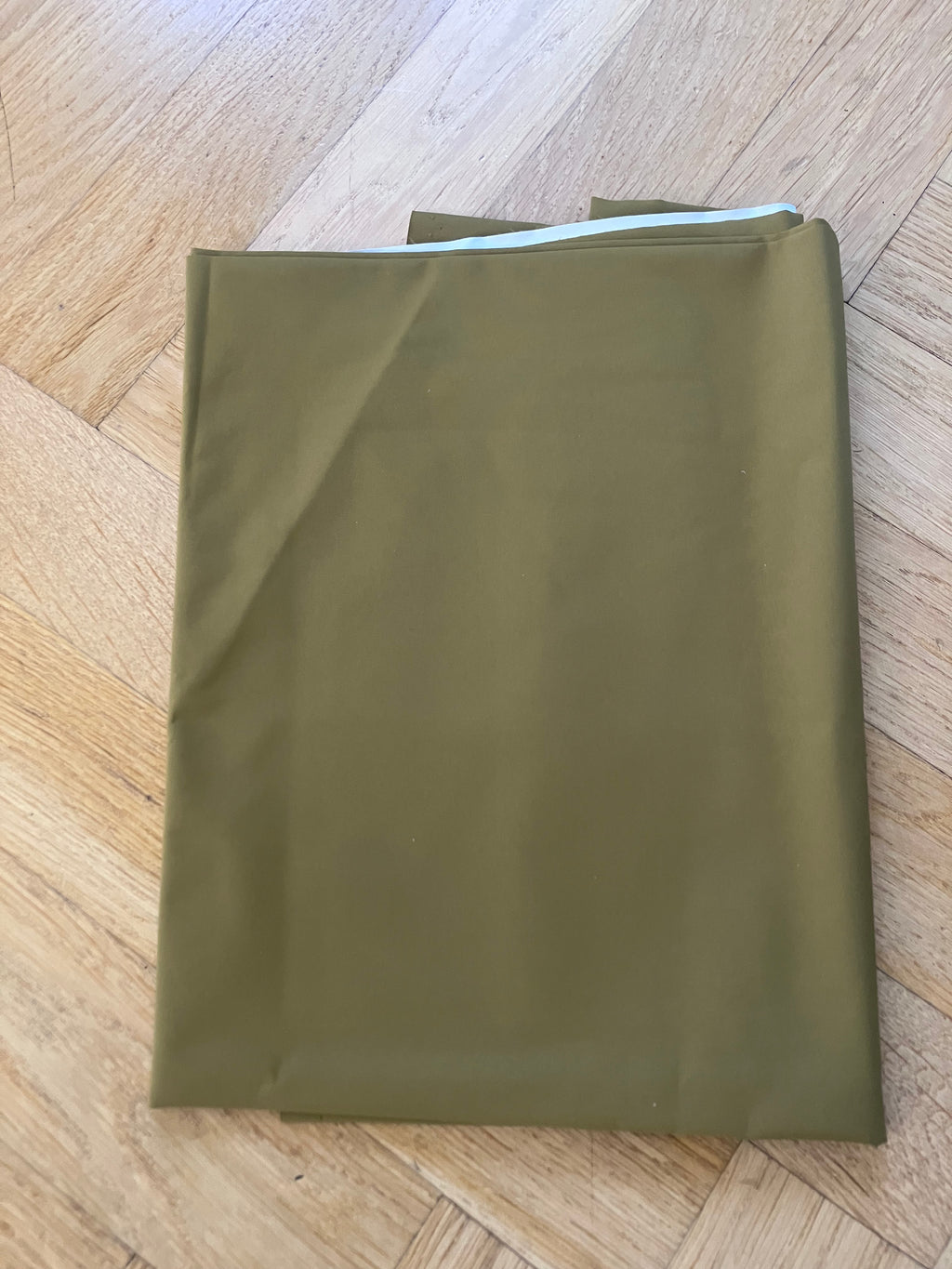 Green envelope on a wooden surface